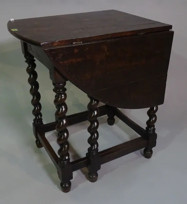 A late 18th century oak gateleg console table on barleytwist supports, 67cm wide x 78cm high.