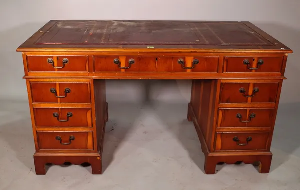 A 20th century yew wood pedestal desk with leather inset top, 136cm wide x 75cm high.