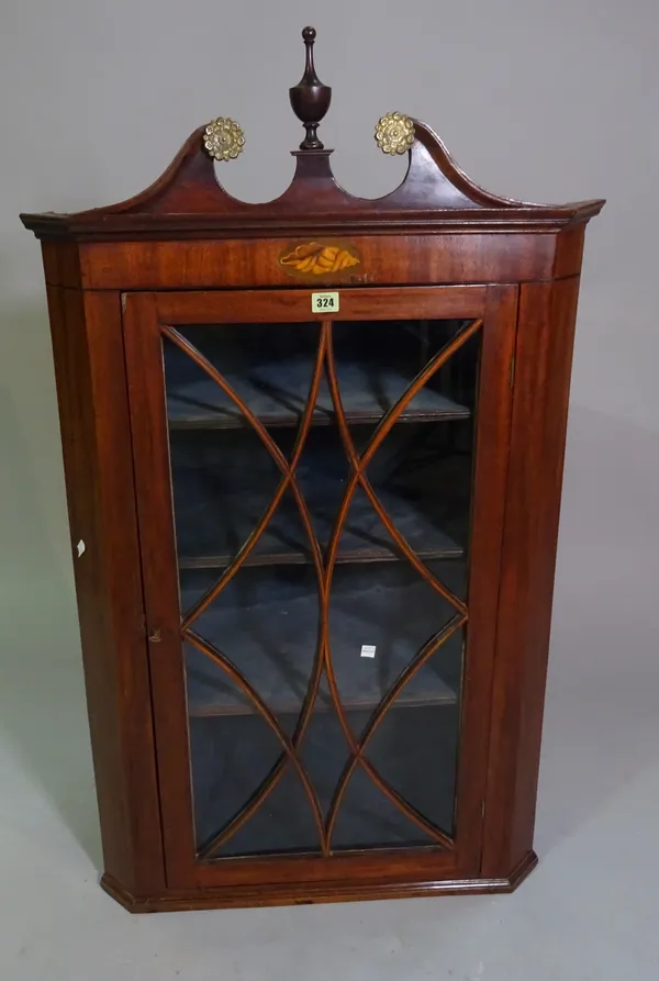 An early 19th century mahogany and glazed corner cupboard with swan neck pediment, 116cm high x 70cm wide.