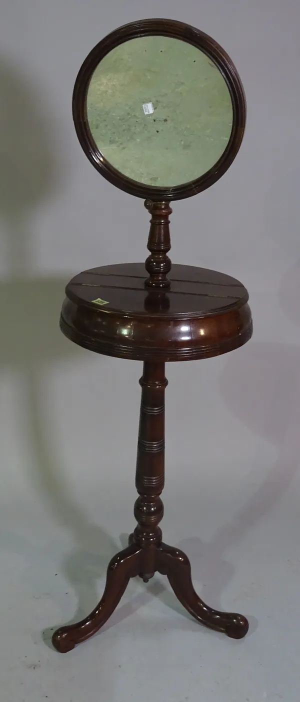 A late Victorian walnut shaving stand on tripod base, 145cm high.