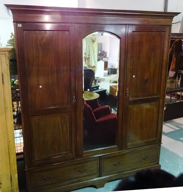 An Edwardian mahogany triple wardrobe with mirrored door, 184cm wide x 215cm high.