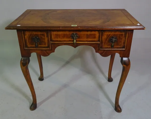 A Queen Anne style walnut lowboy on tapering pad feet, 84cm wide x 71cm high.