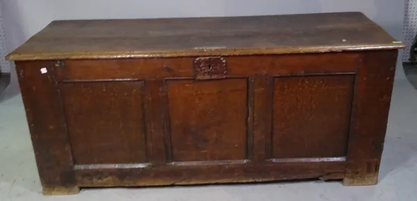 A 17th century and later oak coffer, with triple panel front, 154cm wide x 64cm high.