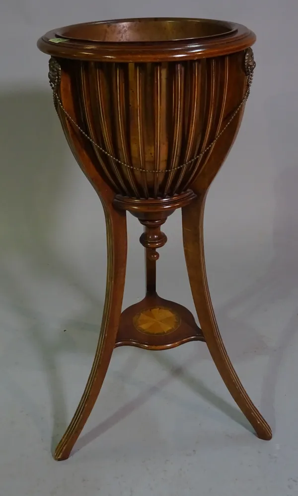 An early 20th century inlaid mahogany jardinière, the open slatted body on three splayed supports, 36cm diameter x 85cm high.