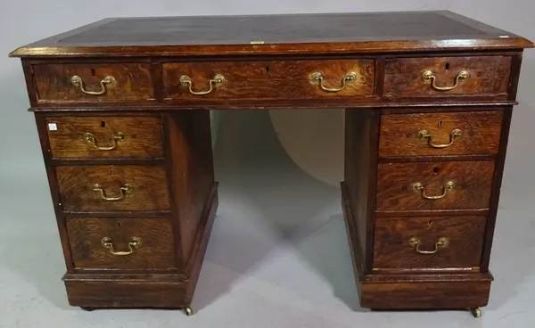 An early 20th century oak pedestal desk with brown leather inset top, 122cm wide x 83cm high.