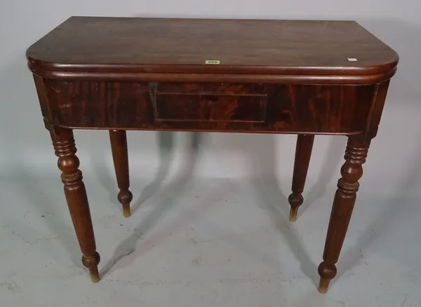 An early Victorian mahogany foldover tea table, on ring turned tapering supports, 89cm wide x 71cm high.