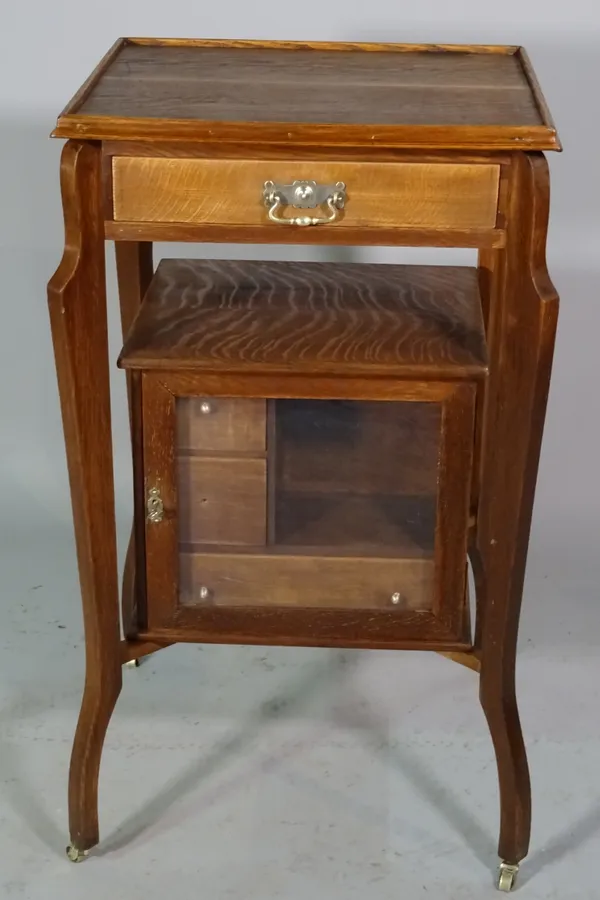 An early 20th century oak what-not with cabinet base, 49cm wide x 86cm high.