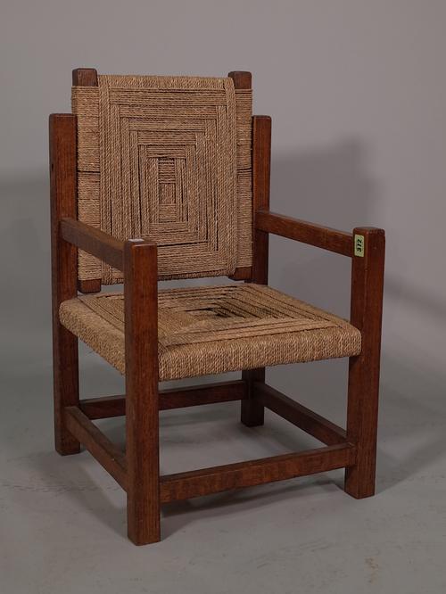 A 20th century oak framed child's green armchair with reversible back on square supports, 39cm wide x 65cm high.