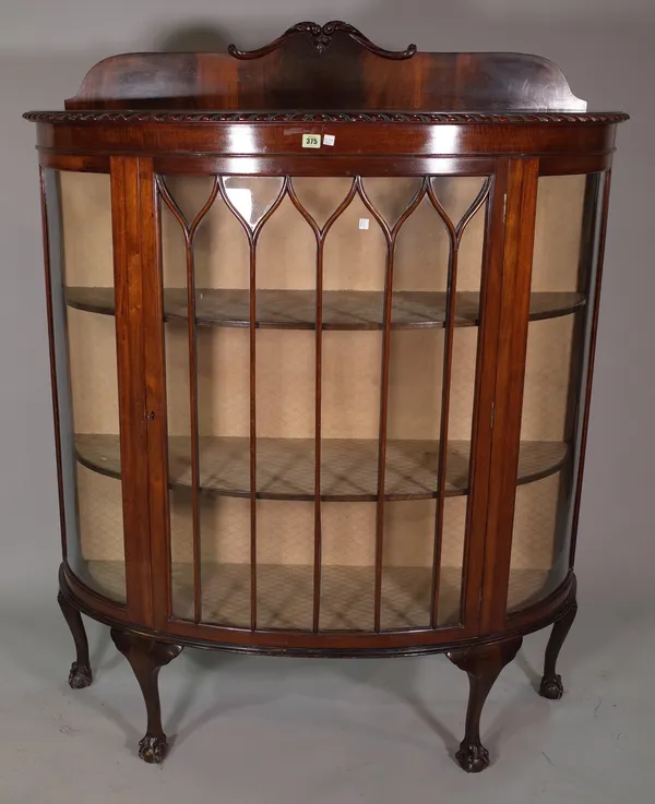 A Victorian style mahogany bowfront display cabinet on ball and claw feet, 26cm wide x 155cm high.