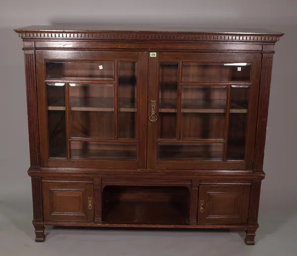 A 19th century oak side cabinet with fluted edges on block supports.