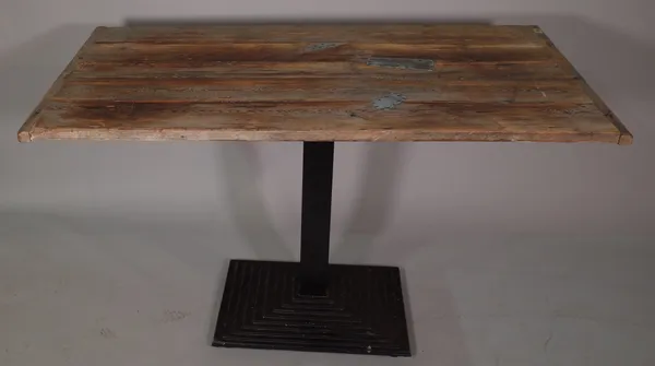 A 20th century stained pine rectangular dining table on black painted metal tiered base, 130cm wide x 80cm high, and a 20th century stained pine bench