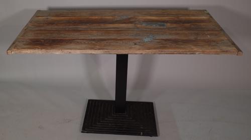 A 20th century stained pine rectangular dining table on black painted metal tiered base, 130cm wide x 80cm high, and a 20th century stained pine bench