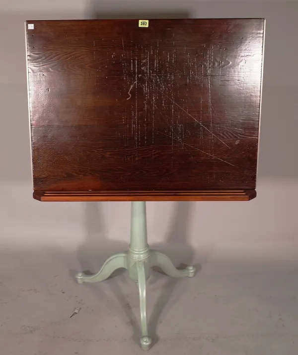 A mid-20th century architect's table, the stained pine angle adjustable top on a cast iron tripod base, 80cm wide.