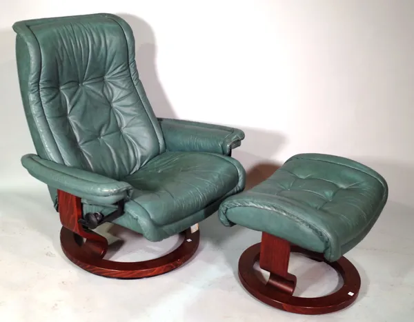 A 20th century faux green leather ergonomic reclining armchair and matching stool, (2).