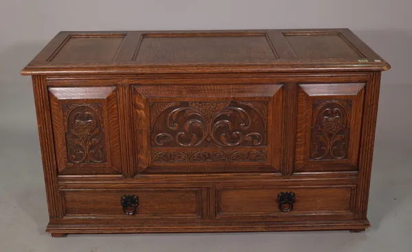 A 20th century oak mule chest with carved panel decoration, 124cm wide.