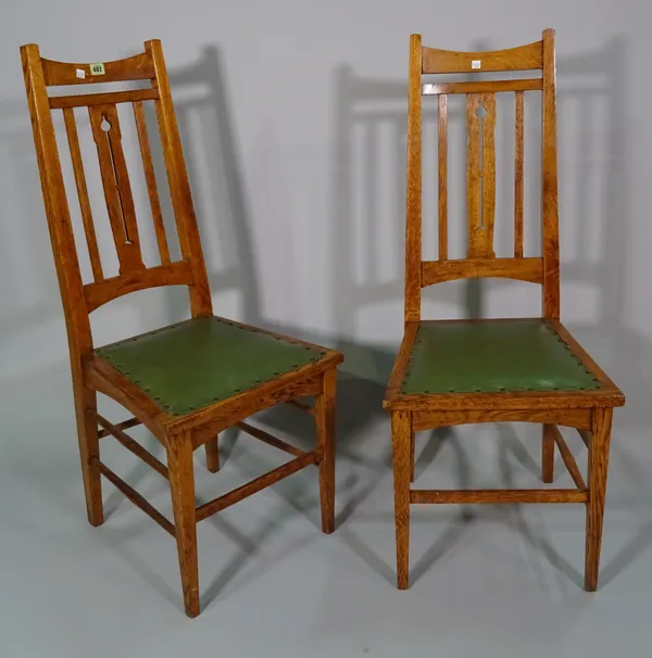 A pair of Arts and Crafts oak side chairs, on tapering square supports, 44cm wide x 108cm high.