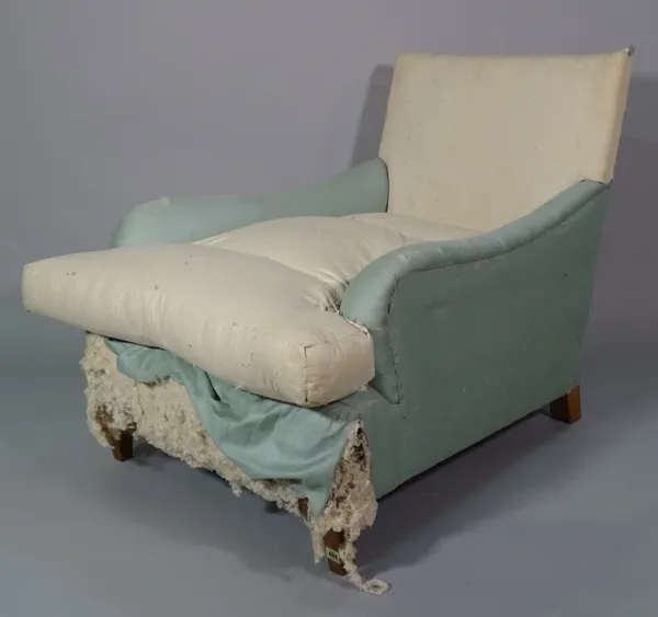 An early 20th century easy armchair on tapering square supports, 80cm wide x 77cm high.