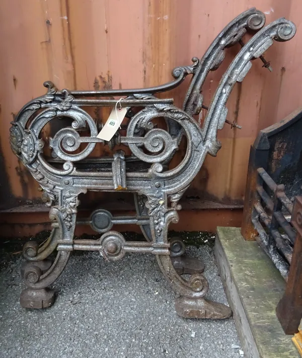 A pair of early 20th century cast iron bench ends, 80cm high, (2).