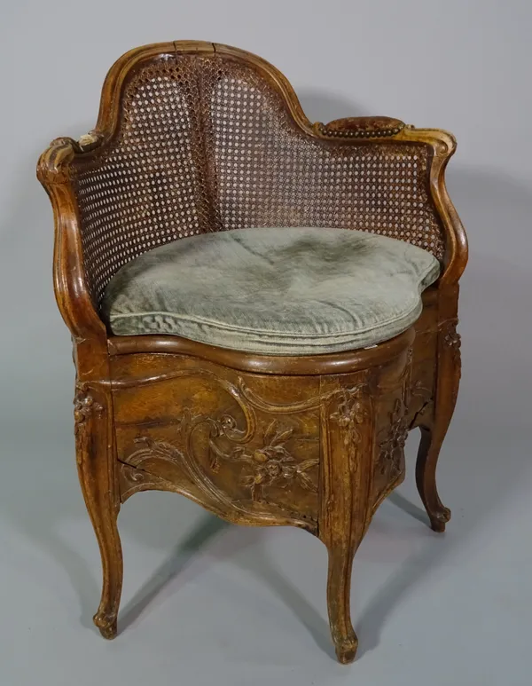 A Louis XV style beech commode chair.