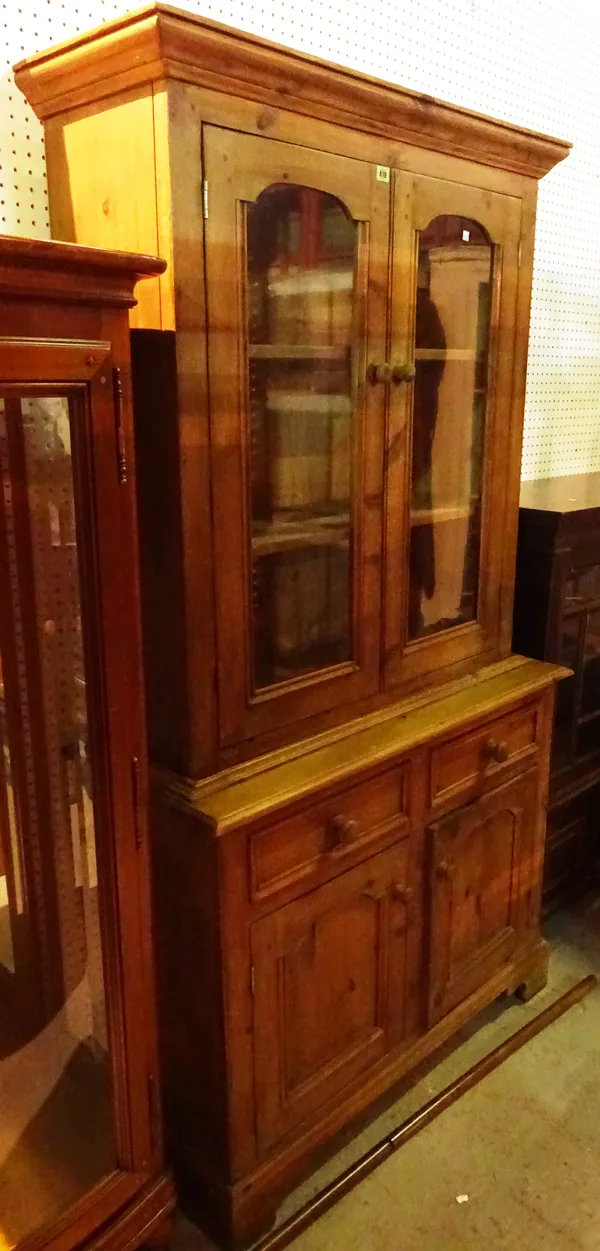 A 20th century pine dresser with glazed two door top over cupboard base, 112cm wide x 195cm high.