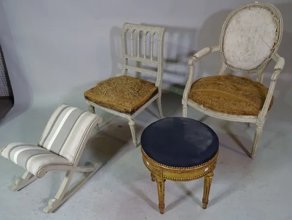 A Louis XVI style grey painted open armchair, a similar low chair, an 'X' frame footstool and a French gold painted footstool, (4).