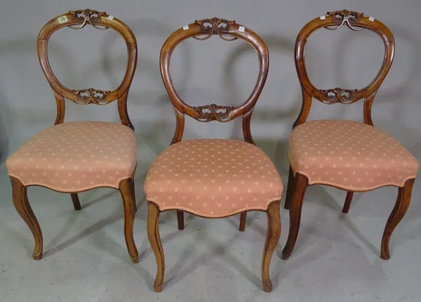 A set of four Victorian walnut balloon back dining chairs, together with another similar, (5).