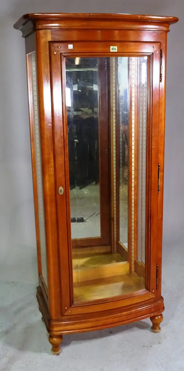 A modern mahogany bowfront display cabinet on turned supports, 65cm wide x 166cm high.