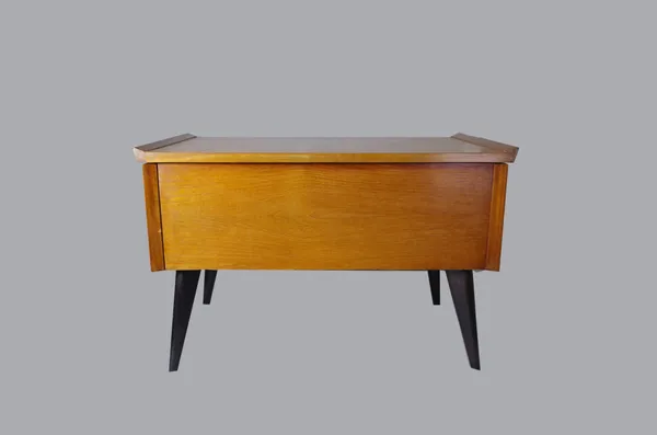 A 1970s teak sewing table, rectangular form, hinged lid above green material lining and compartments, ebonised angled legs, 62cm wide x 42.5cm high x