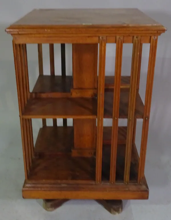 An early 20th century stained oak revolving bookcase, 92cm high x 56cm sq.