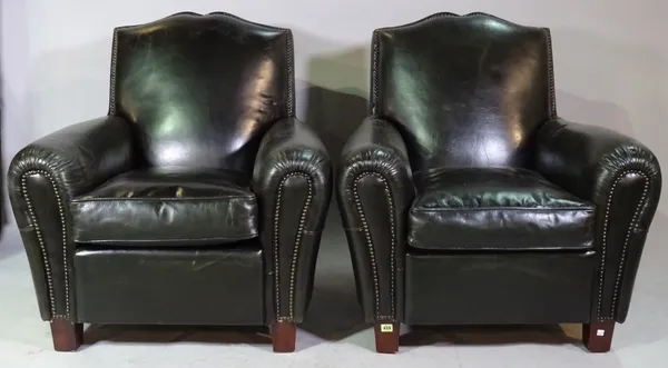 A pair of 20th century brass studded green leather upholstered easy armchairs on tapering block supports, 90cm wide x 100cm high.