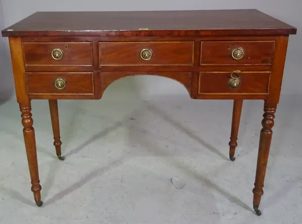 A Victorian mahogany kneehole dressing table on ring turned supports, 102cm wide x 80cm high.