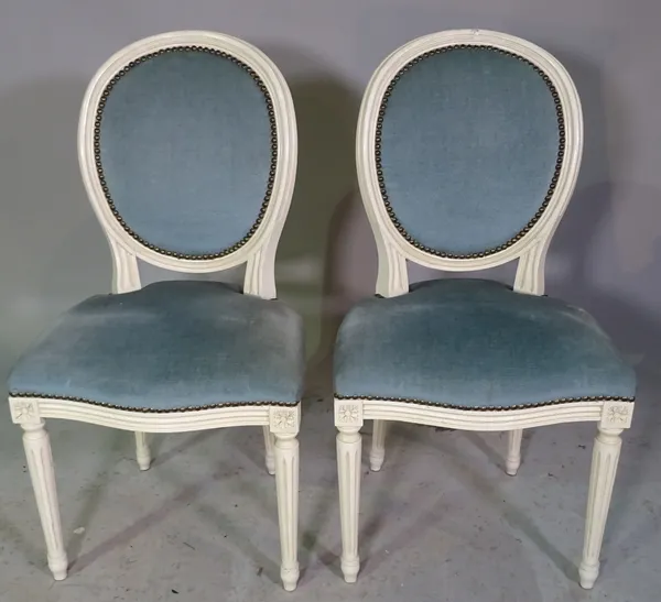 A set of six white painted Louis XVI style oval back dining chairs, on fluted supports, 49cm wide x 91cm high, (6).