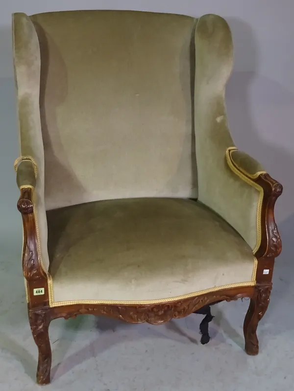 A 19th century French floral carved walnut framed square wingback armchair on scroll supports, 83cm wide x 115cm high.