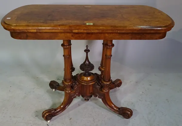 A Victorian walnut and inlaid oval card table on outswept supports 98cm wide x 75cm high.