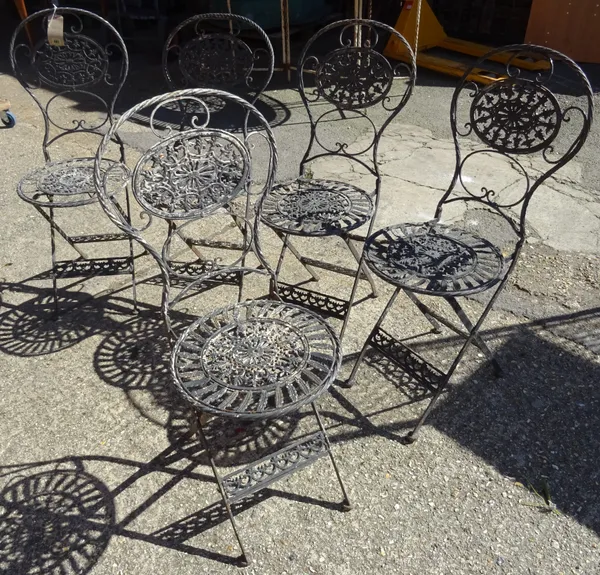 A set of five early 20th century black painted metal folding garden chairs and a white painted open armchair, (6).