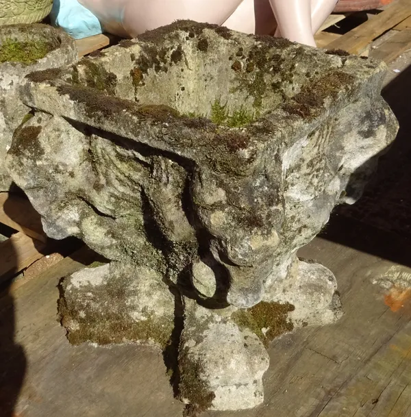 A reconstituted stone jardiniere with four opposing lions, 40cm wide x 40cm high.