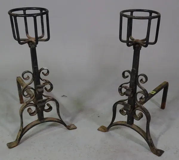 A pair of wrought iron fire dogs, 45cm long x 65cm high.