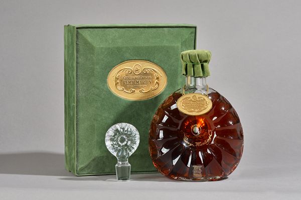 One bottle 1985 Remy Martin Centaure Cognac, in crystal decanter and presentation box. Illustrated.