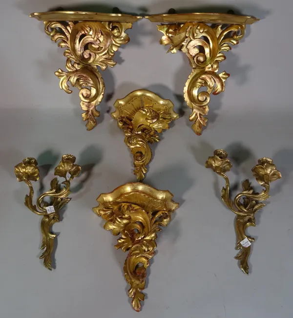 Two pairs of Italian Florentine giltwood wall brackets and a pair of gilt metal wall brackets, the largest pair 36cm wide x 34cm high.