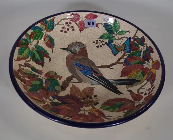 Emaux de Longwy; a French pottery dish, polychrome decorated with a kookaburra within a wide foliate border, black printed mark, 38cm diameter.