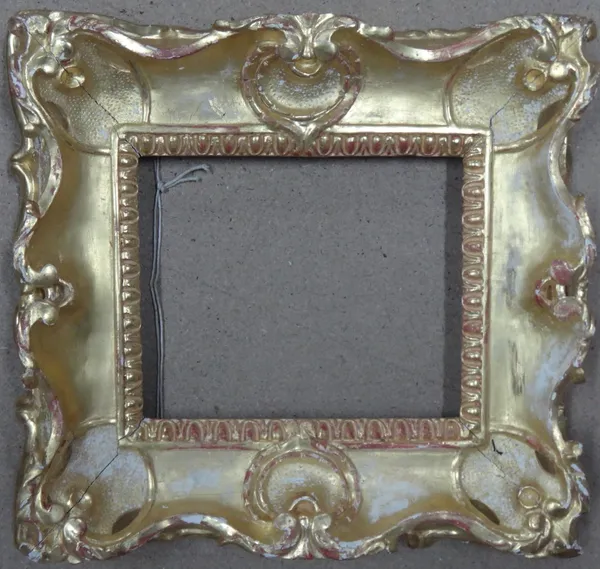 An 18th century and later carved giltwood frame, aperture 28cm x 22cm.