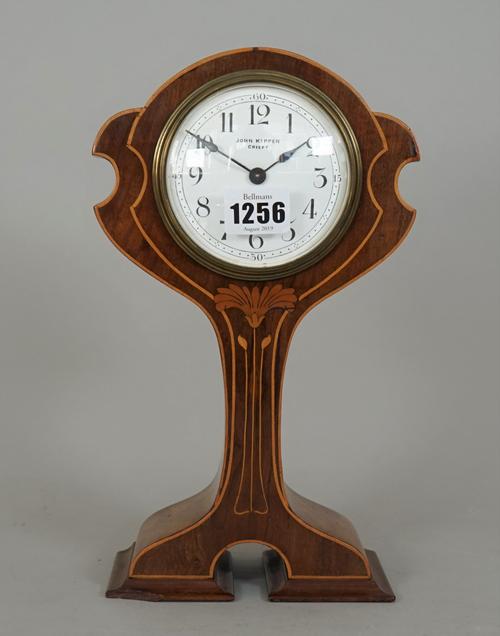 A mahogany and inlaid mantel clock of Art Nouveau design, the white enamel dial detailed John Kippen Crieff, (a.f.), 27cm high.