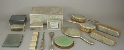 A quantity of shagreen mounted dressing table wares, early 20th century and later, including a manicure box (25.5cm wide), a small strut back desk cal