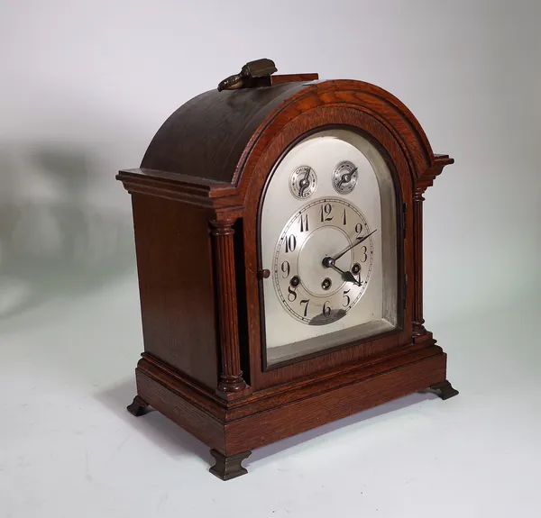 A 1920s oak cased eight day mantel clock with German 'Junghans' movement, 37cm high, (key and pendulum).