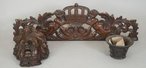 A 17th century cast iron mortar with indistinct marks to body, 7cm high, and early 18th century style carved oak cresting 'Boyes & Crown', 58cm wide a