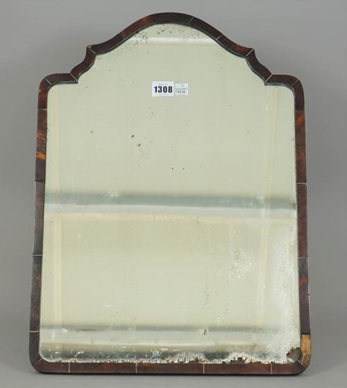 A late Victorian tortoiseshell strut back table mirror, with shaped top over a rectangular frame, (a.f), 52cm high.