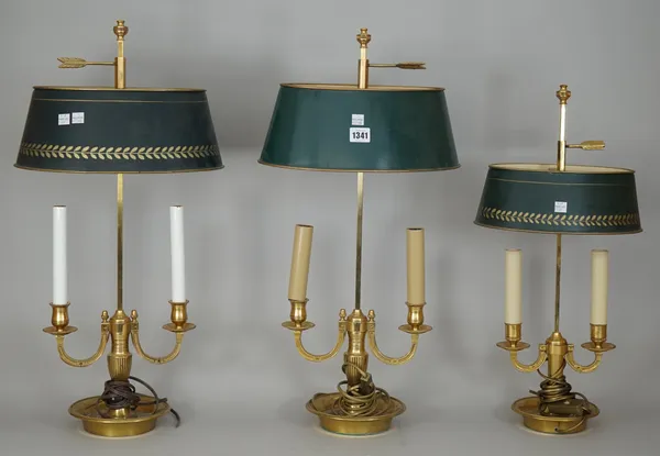 A near pair of Victorian style gilt brass bouillotte twin branch table lamps, with adjustable oval tole peinte shade, 65cm high, and a similar smaller