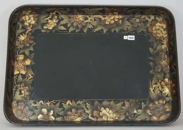 A Victorian papier mache rectangular tray, of large proportions, ebonised with a wide gilt painted foliate border and up-turned rim, unsigned, 78cm wi