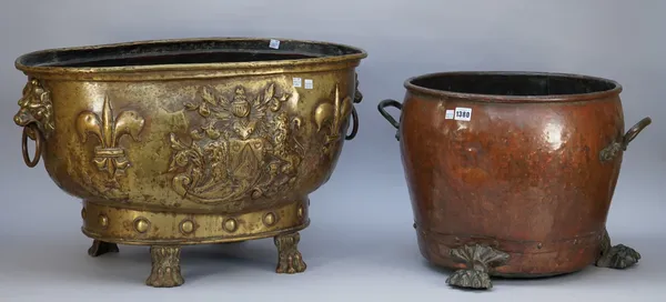 A Victorian copper log bin of circular studded form with twin brass handles and three lion paw feet, 34.5cm high and a gilt copper oval log bin with t