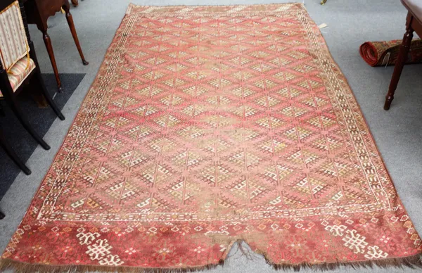 A Yumut carpet, the madder field with diagonal rows of hooked diamonds, three borders, skirt ends, dated 1914, 317cm x 191cm.